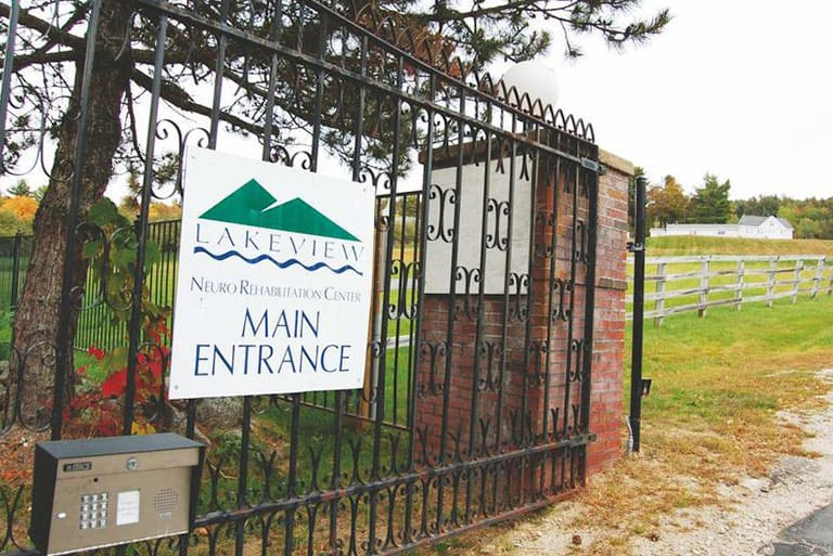 Lakeview Neuro Rehabilitation Center Entrance with sign reading "Main Entrance" on a tall metal fence