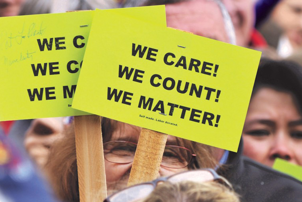 Signs at rally "We Care!" "We Count!" "We Matter!"