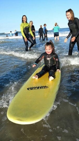 Katie on a yellow surf board