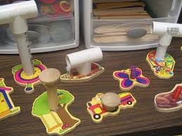 Wooden puzzle with plastic knobs added