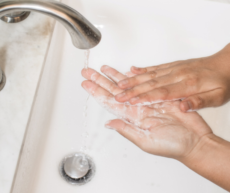 Close up of hands washing in sink
