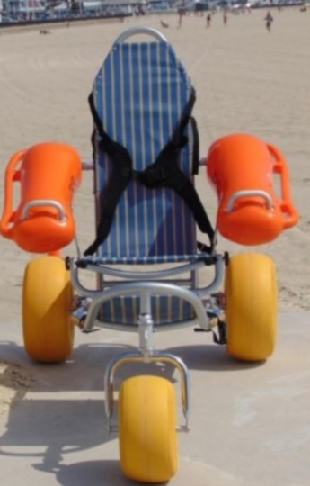 Beach wheelchair with orange floatable arm rests and large yellow wheels on a sandy beach